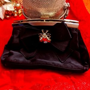 Black Kurt Geiger satin jeweled clutch.